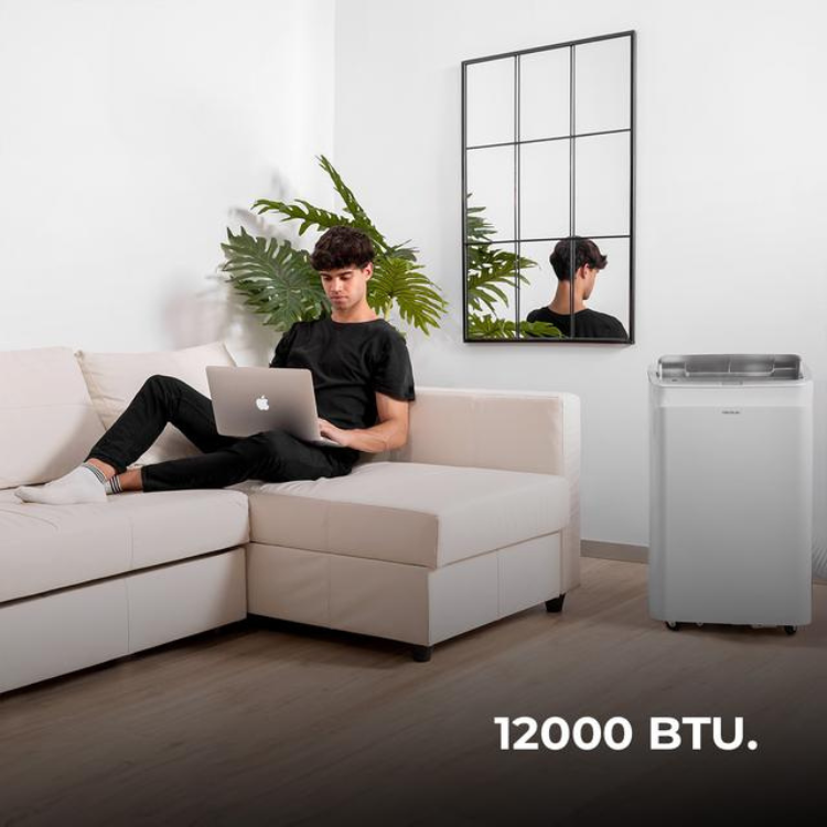 Cecotec ForceClima 12800 portable air conditioner, white, 12000 BTU, next to a couch.