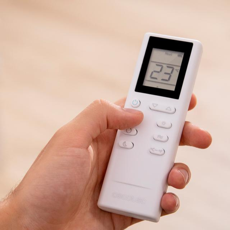 Cecotec portable air conditioner remote control, white, displaying 23°C.