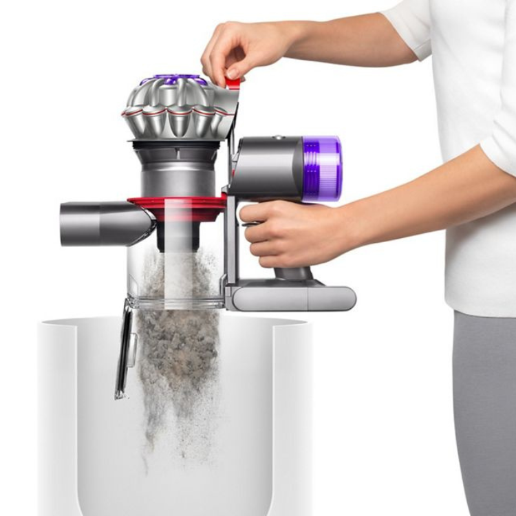 Dyson V8 handheld vacuum cleaner, silver and purple, emptying dust container.