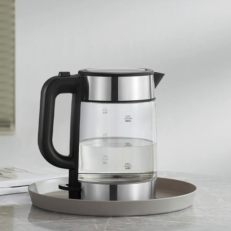 Xiaomi Mi Electric Glass Kettle, clear glass body, black handle, silver lid and base, on a round silver tray.