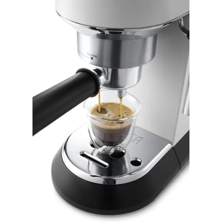 De'Longhi Dedica Style espresso machine in white, dispensing coffee into a glass cup.