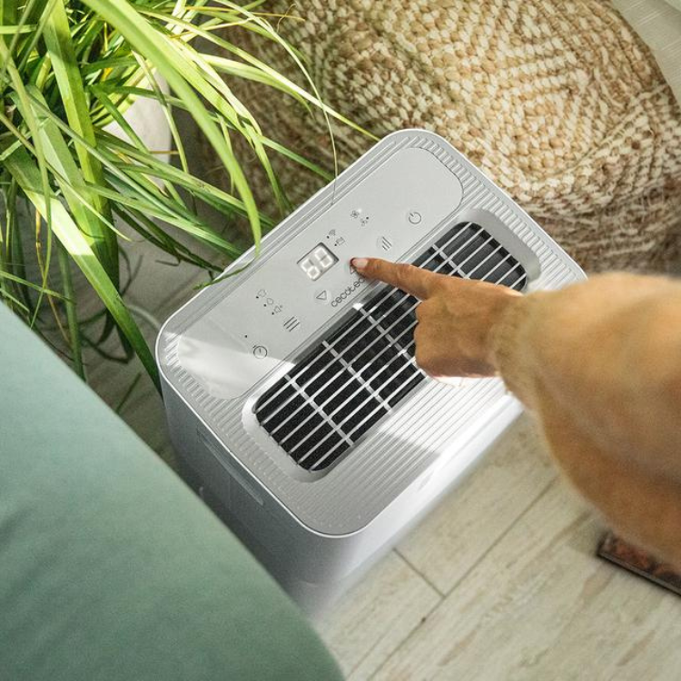 Cecotec BigDry 10000 Expert dehumidifier, silver, with digital display and buttons, finger pressing button.