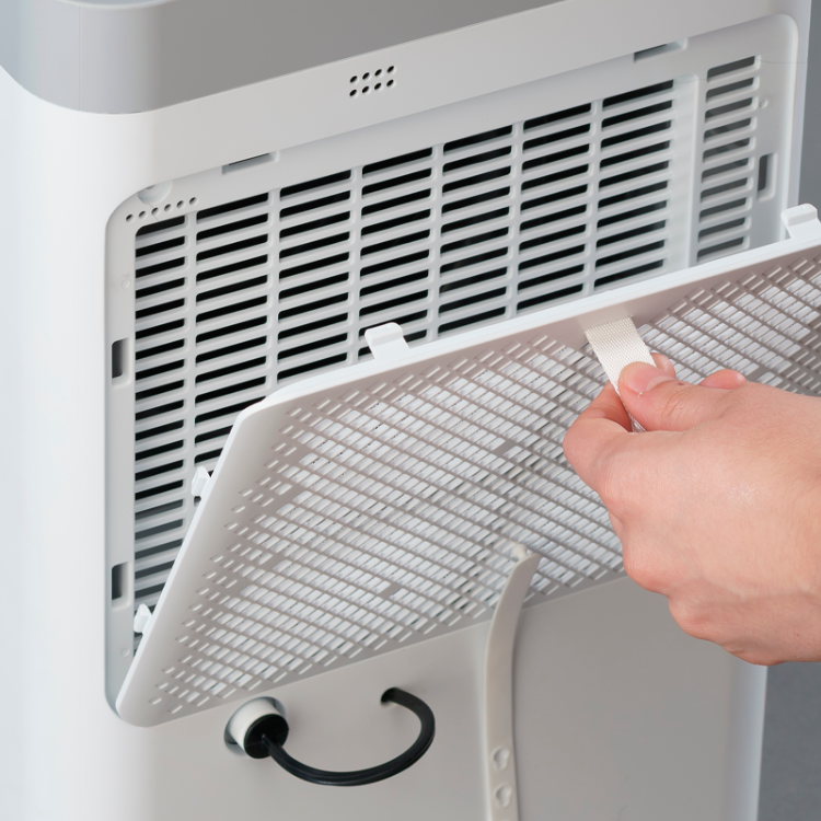 White Jocel dehumidifier filter being cleaned with cloth.