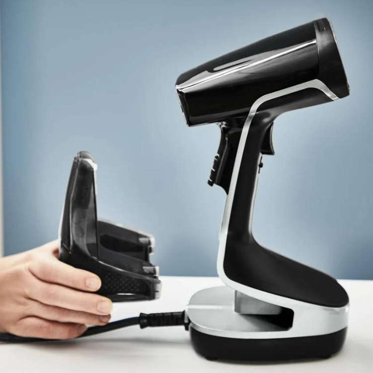 Black Rowenta steam iron standing on a charging dock, 2000W, with interchangeable soleplate.