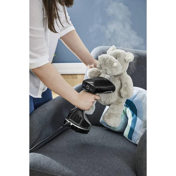 Rowenta vertical steam iron, 2000W, black, steaming teddy bear on couch.