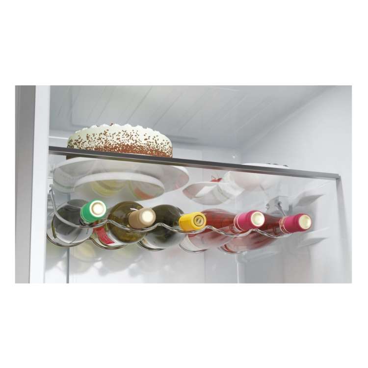 Wine bottles and cake inside Haier fridge.