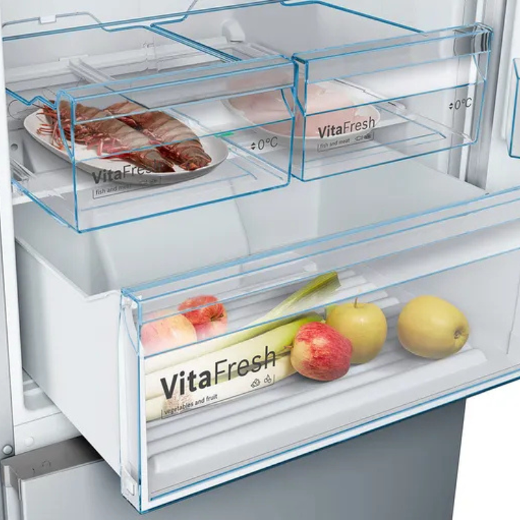Bosch KGN493IDA fridge drawers, clear plastic, with food: fish plate, apples, and vegetables; white and blue; inox finish.