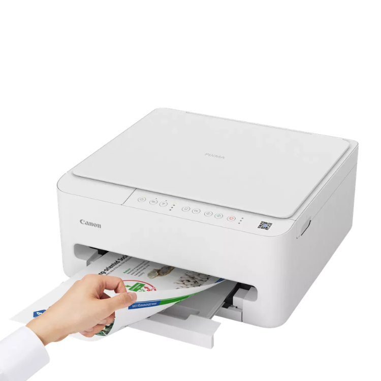 Canon PIXMA TS4150i white inkjet printer with hand pulling out printed paper