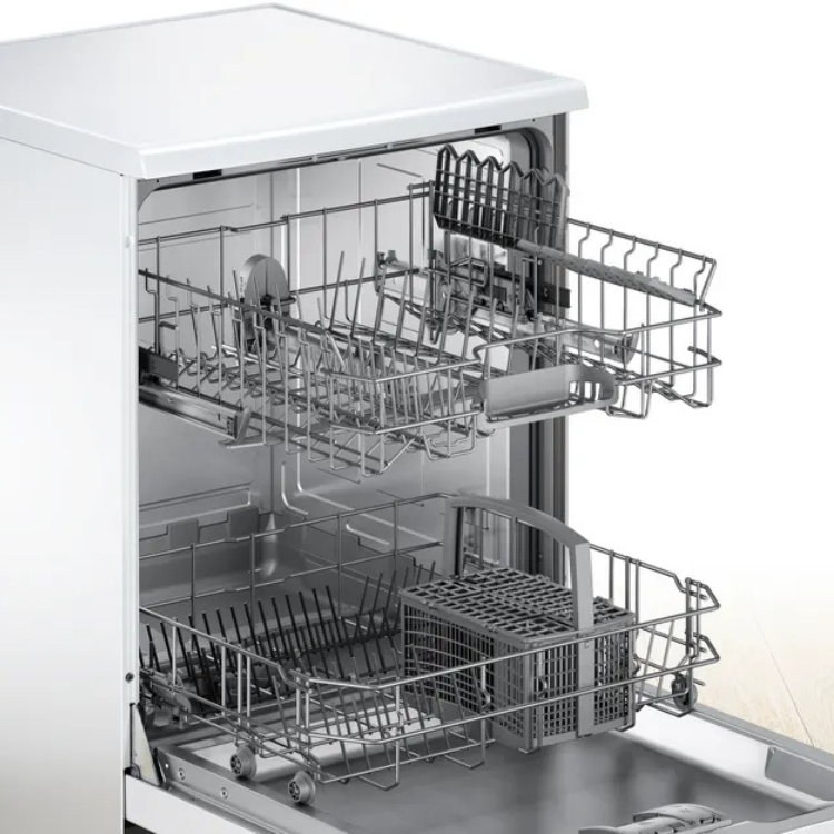 Bosch Serie 2 white dishwasher interior with open door, two racks and utensil holder.