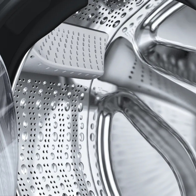 Bosch Serie 6 washing machine drum, stainless steel with holes and water droplets.