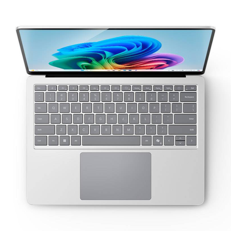 Microsoft Surface Laptop, silver, 13.8" screen with colorful wallpaper, open on keyboard.