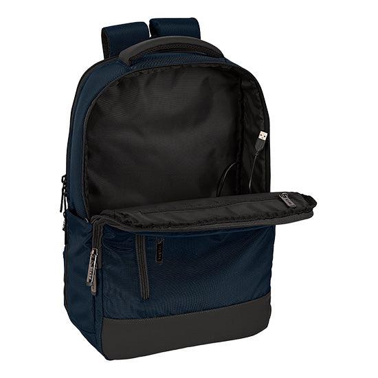 Mochila Safta Business 15.6" USB, azul escuro, com compartimento interno e bolsos laterais.