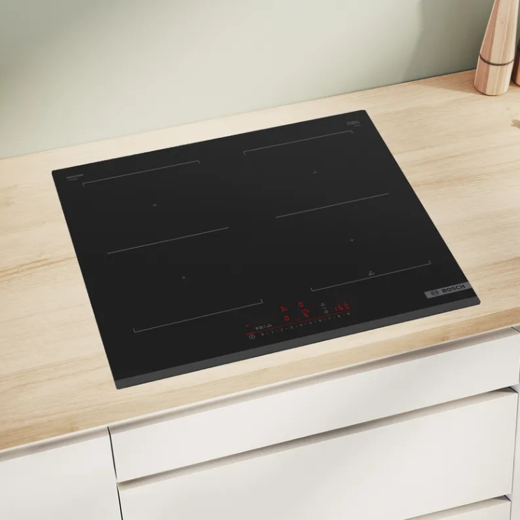 Black Bosch induction cooktop, Serie 6, 4 zones, 60cm, on light wood countertop.