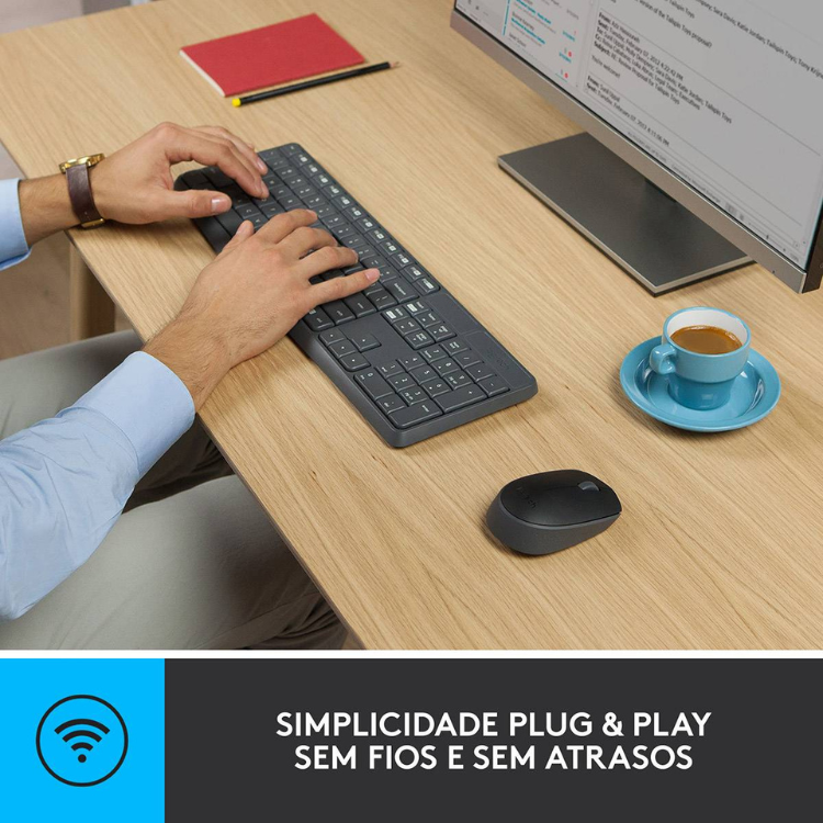 Logitech MK235 wireless keyboard and mouse set, black, on a desk with a person typing.
