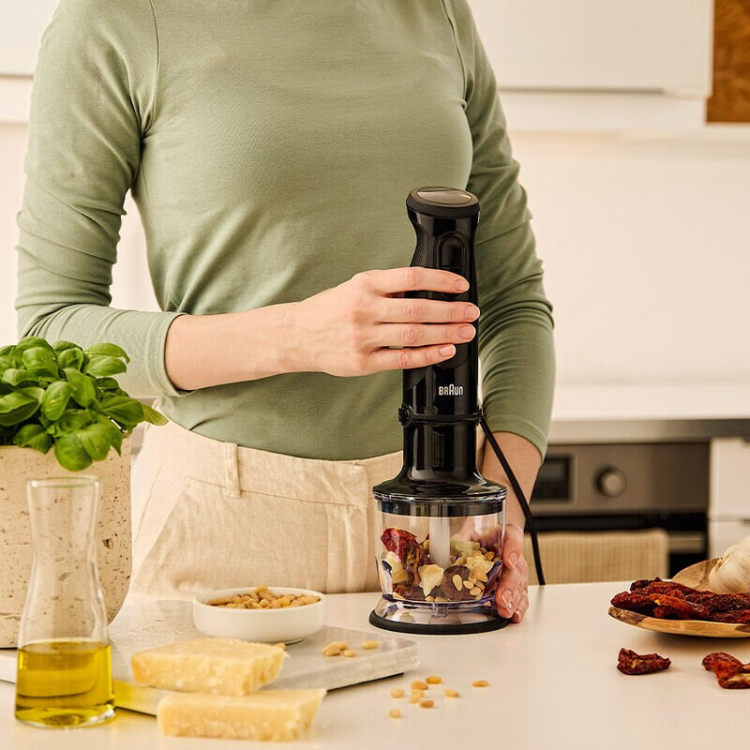 Black Braun MultiQuick 3 hand blender with clear container on kitchen counter.
