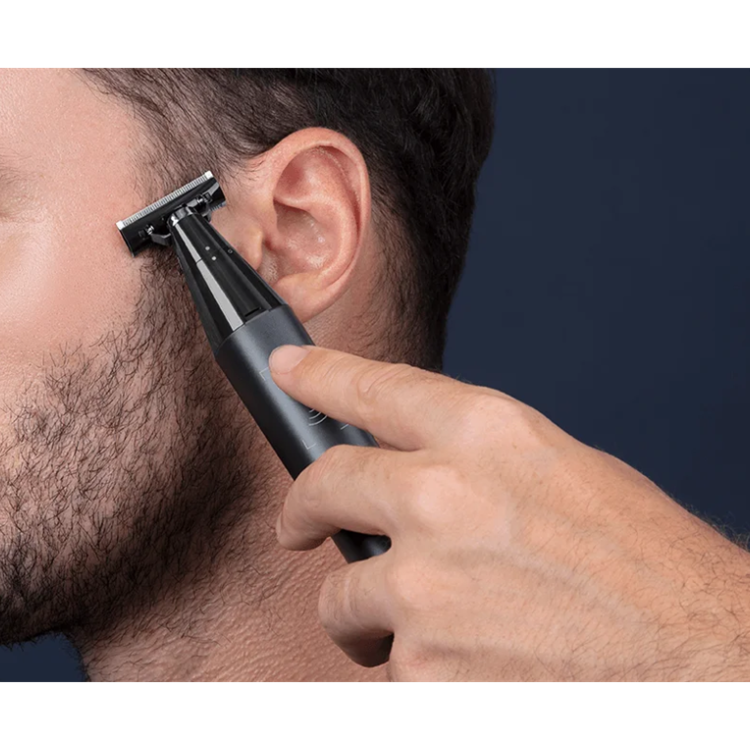 Black Xiaomi Uniblade Trimmer shaving man's cheek.