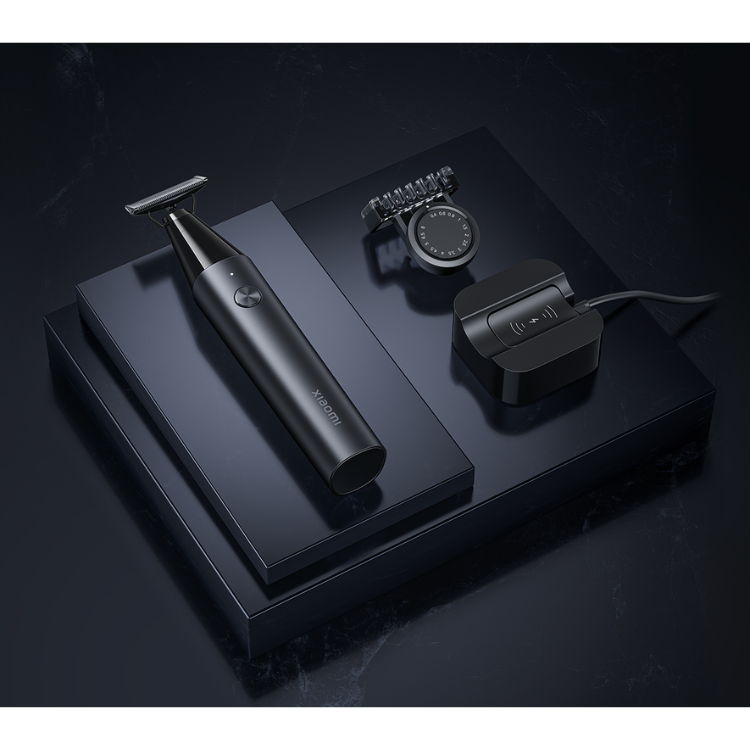 Black Xiaomi Uniblade Trimmer with charging dock and attachments on black box.